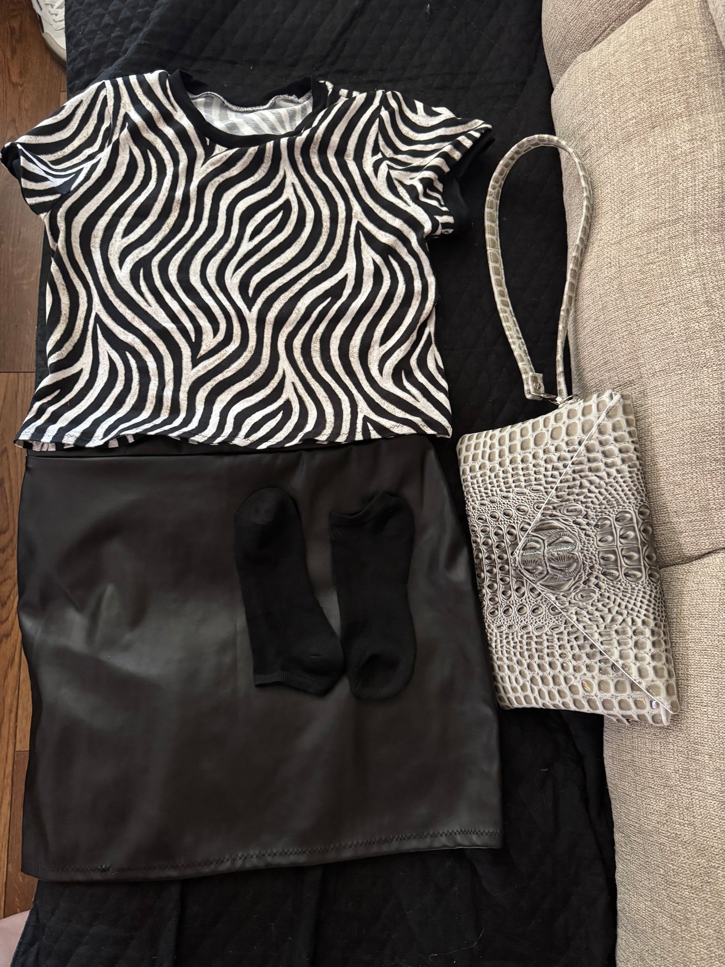 Gray croc vinyl envelope crossbody bag styled with black leather skirt and zebra print top